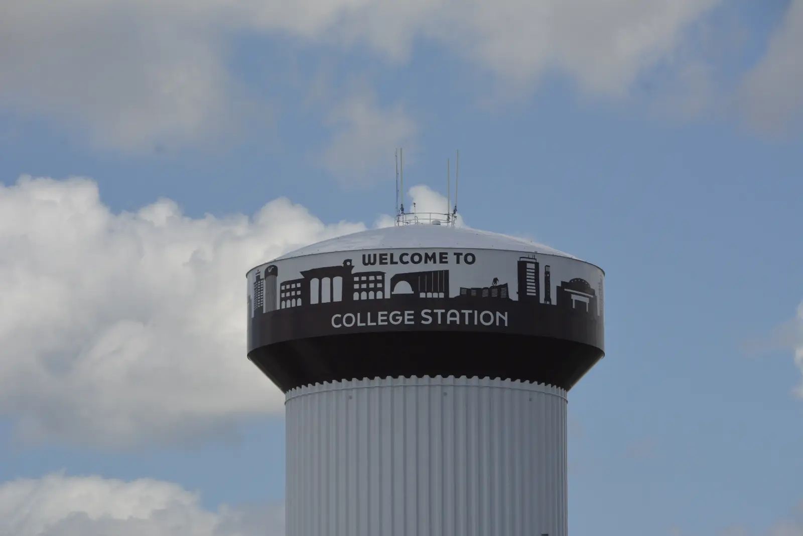 College Station water tower featuring the city skyline