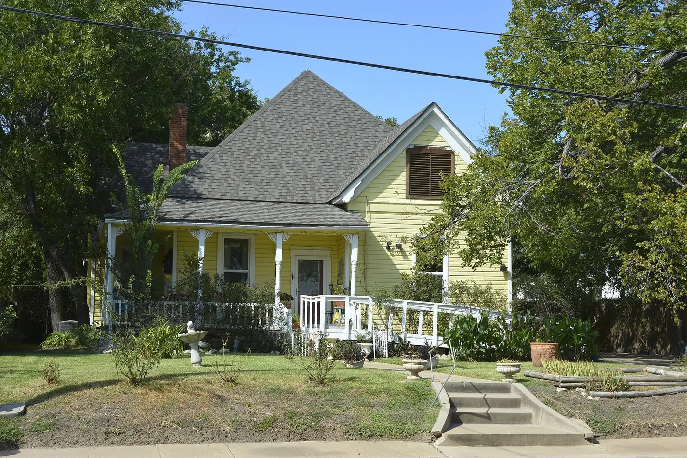 Older Bryan home with landscaping and mature trees