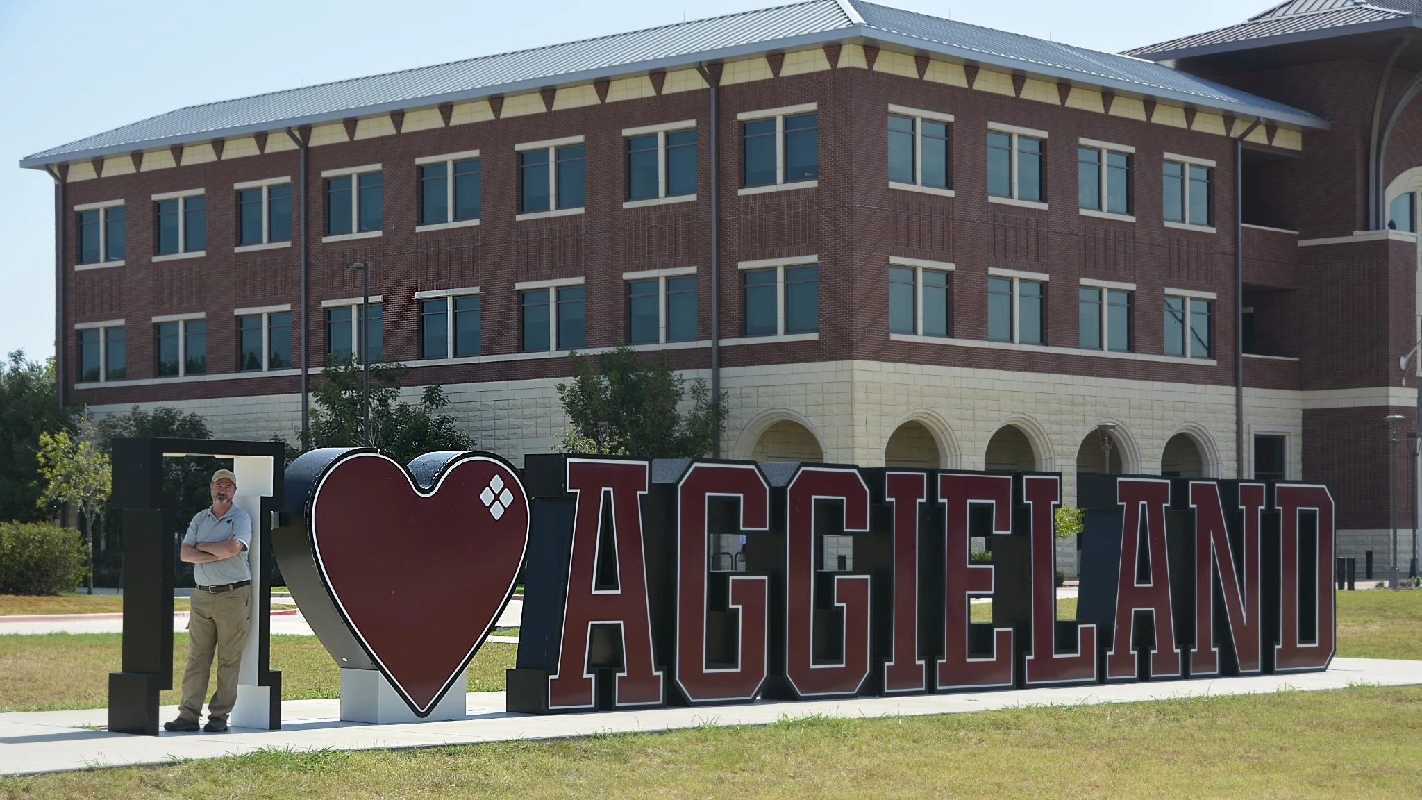Dr. Scott Lingren at the I love Aggieland sign